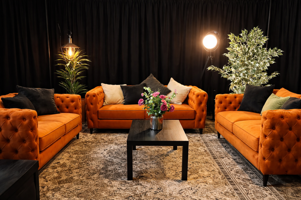 Orange sofa's in a green room